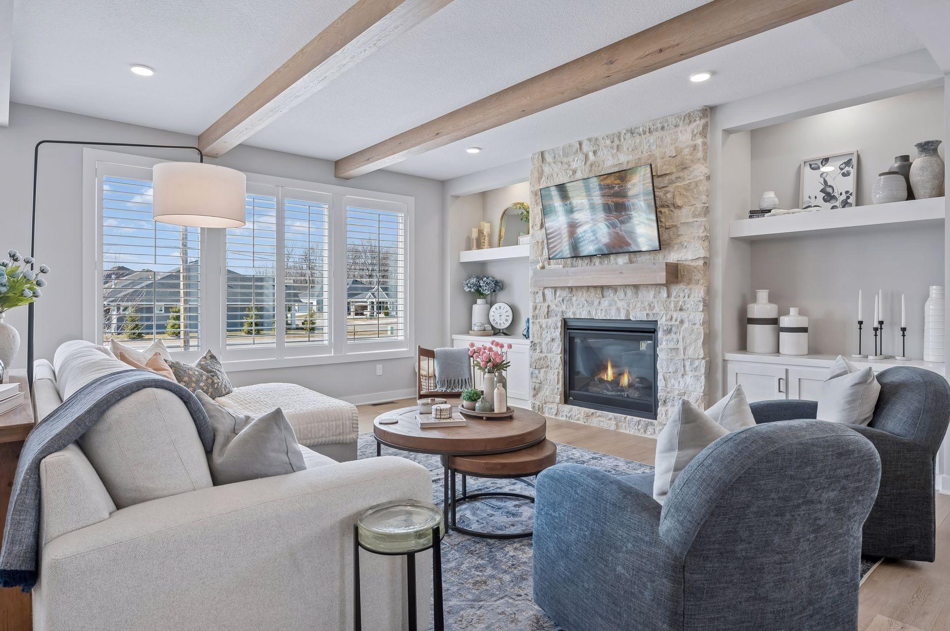 Main level living room with white oak floors and ceiling beams