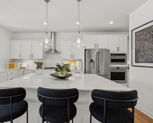 (Photo of a decorated model, actual finishes will vary) The spacious kitchen naturally serves as the heart of this home, complete with a generous center island, brand-new appliances and a walk-in pantry.