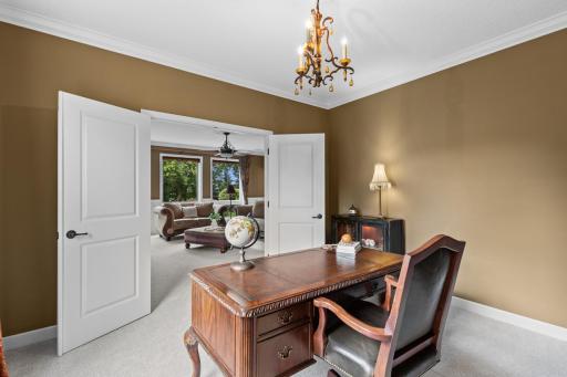 Conveniently tucked just off the main living area, the home office is framed by double doors for added privacy and charm.