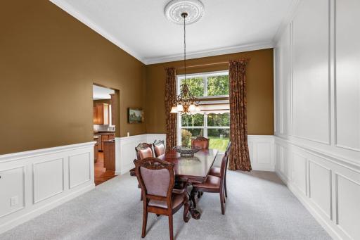 The formal dining area looks out over the peaceful backyard, offering a warm and welcoming ambiance for entertaining or everyday dining.
