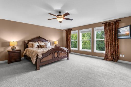 Primary suite features a private sitting room/office, dual walk-in closets, and a spa-like ensuite.
