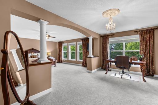 Primary suite features a private sitting room/office, dual walk-in closets, and a spa-like ensuite.