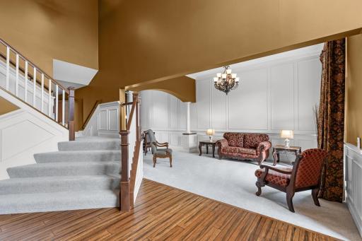 A statement chandelier graces the living space just beyond the foyer, highlighting the roomâs soaring ceilings and the homeâs thoughtful craftsmanship throughout.