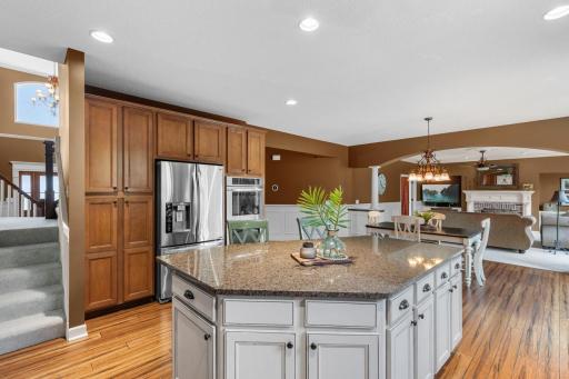 Gourmet kitchen with center island and seamless flow to dining areas.