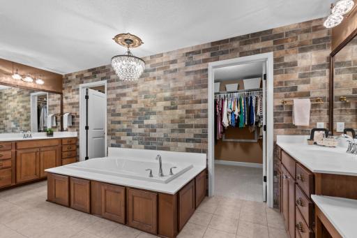 Ensuite includes a soaking tub, walk-in shower, and upgraded finishes for a peaceful retreat.