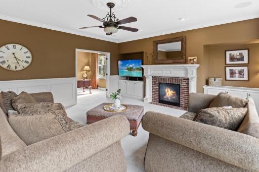 Custom crown molding and wainscoting woodwork showcase attention to detail and craftsmanship.