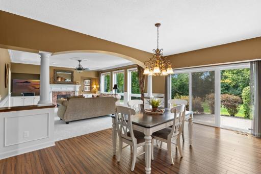 Thoughtfully designed with refined touches, the home features a stunning arched opening that elegantly defines the space between the informal dining and living rooms.