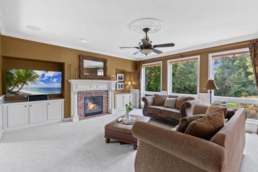 Family room with gas fireplace and custom built-insâideal for cozy evenings or entertaining.