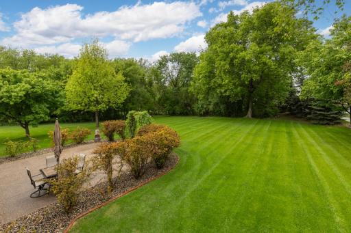 Lush, vibrant landscaping surrounds the home with rich greenery.