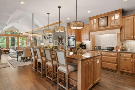 The kitchen is a culinary masterpiece, featuring a spacious center island, granite countertops, beautiful maple cabinets with tons of storage. The open-concept design invites effortless conversation and connection from every room.