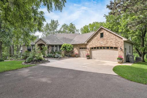 Located on a quiet cul-de-sac, this elegant 4 bedroom, 4 bath rambler offers a spacious 3-car garage, expansive driveway, and beautifully maintained grounds surrounded by towering trees for added privacy.