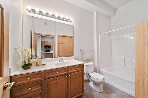 Bathroom is nice and bright and has a jetted tub. (Virtually staged)
