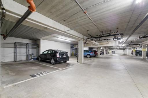 Garage stall #116 is conveniently located right by stairs and has a metal, lockable storage cage.