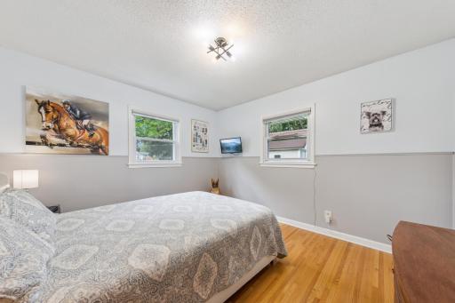 One of 3 bedrooms on the main level. Hardwood floors and updated light fixtures.jpeg
