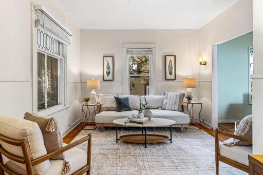 So much character with high ceilings, original hardwood floors, and a large leaded glass window.
