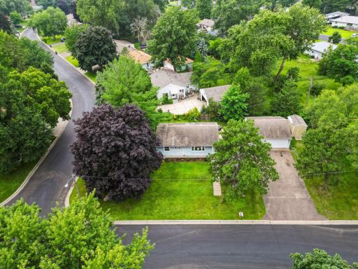 Welcome home! Corner lot with mature trees, wide driveway, and oversized garage - packed with curb appeal.