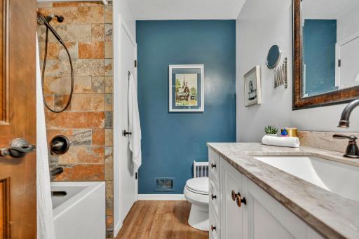 Tiled surfaces, beautiful fixtures, updated vanity.