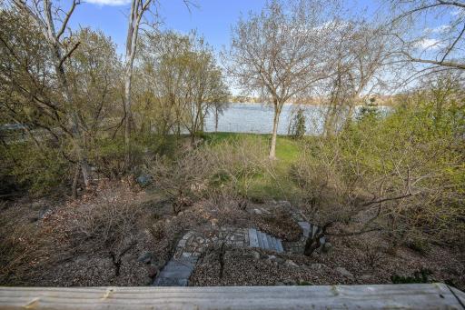 Firepit in trees tucked away for campfires and entertaining. There is also a utility shed below to store water toys, outdoor furniture and lawnmower. - Seller is willing to sell the lawnmower as well.