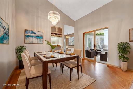 virtual photo of Formal dining room - large sliding glass doors brings you out into the porch which gives you even better views of the lake