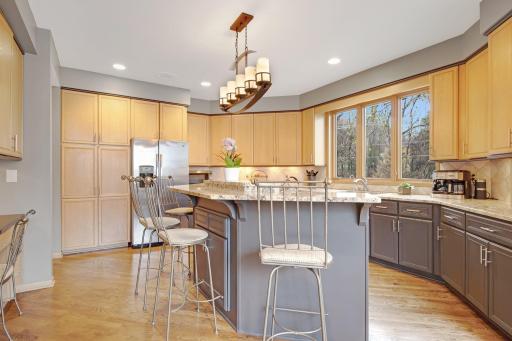 The open concept kitchen has granite counter tops and a lot of storage.