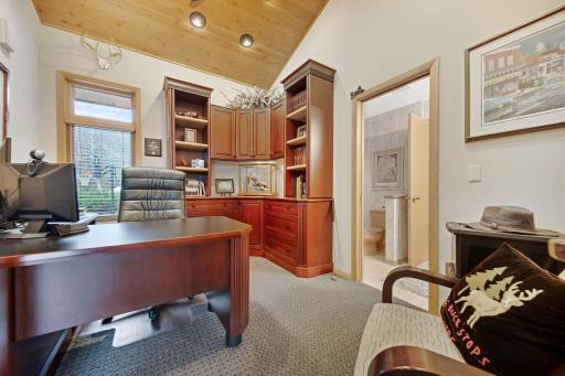 Main floor study - could also be converted into a nursery or main floor bedroom - pocket door leads to a full bath and another door on the other side of the bathroom. Cherry built in shelving with large Cherry desk.