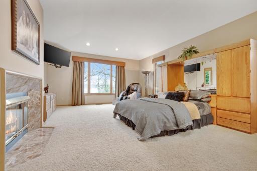 Main floor Primary bedroom with gas fireplace overlooking Lake Virginia