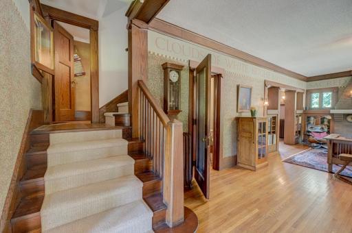 Grand staircase features original woodwork and a new wool runner.