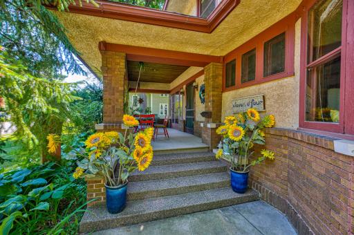Enjoy this welcoming covered front porch, 1 of 5 in this incredible home.
