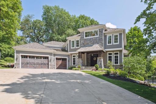 Stunning home in the Wayzata SD at the end of a cul-de-sac, set on a 1 acre, private, tree lined lot