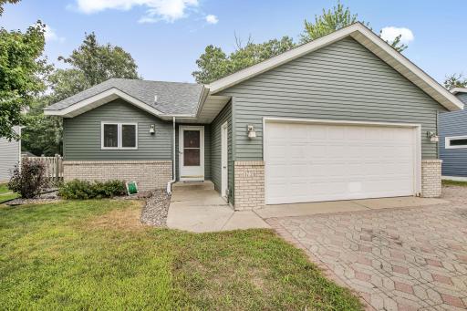 Welcome to this lovely home featuring a paver stone driveway and 2 stall attached garage.. Steel siding with timeless brick accents, architectural shingles, and seamless rain gutters.