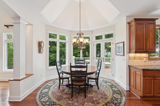 Breakfast room with windows overlooking backyard