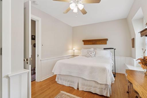 Upper-level bedroom 2 with hardwood floors and classic wainscoting