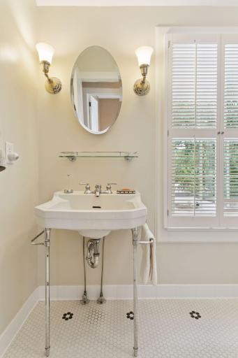 Timeless full bath featuring a pedestal sink and vintage lighting
