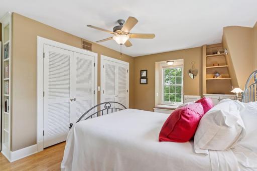 Primary bedroom with original hardwood floors and 2 closets