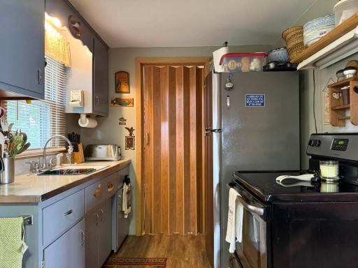 A look at the kitchen, showing the bi-fold door at the rear that leads to the 2nd bedroom.