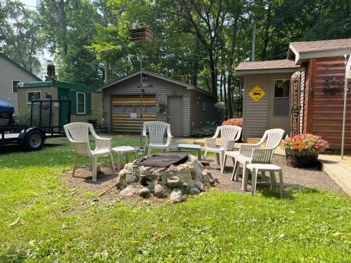 One more view of the firepit ring with the cabin and buildings beyond.