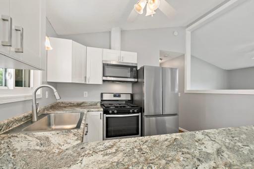 Remodeled kitchen with newer countertops, sink and appliances.