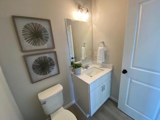 Main floor powder room with vanity for storage, and quartz countertops.