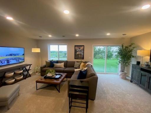 Finished lower level with 5th bedroom and 4th bathroom. This home is on a lookout lot (not a walkout lot) Photos taken from model of similar floor plan. Photos may not depict actual home plan configuration.