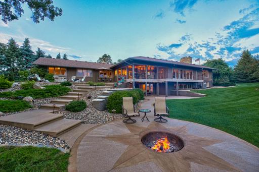 Enjoy the expansive & beautifully landscaped backyard, covered deck, and patio, plus other outdoor amenities including a charming front porch, firepit patio, and a peaceful water feature.