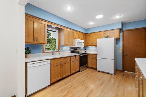 Updated Kitchen has hard surface countertops, window for view of back yard and a Solar Tube for natural lighting