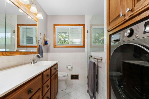 Fully remodeled 3/4 bath on main level with walk-in shower (2024), tile floors and washer/dryer combo unit with heat pump and no vent required!