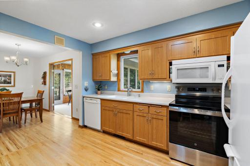 Updated Kitchen has hard surface countertops, window for view of back yard and a Solar Tube for natural lighting