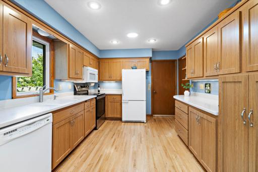 Updated Kitchen has hard surface countertops, window for view of back yard and a Solar Tube for natural lighting