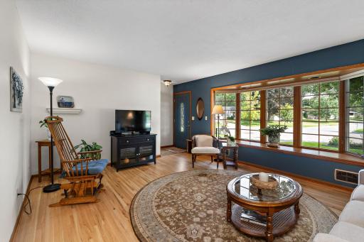 Main Floor Living Room has bay windows and hardwood floors