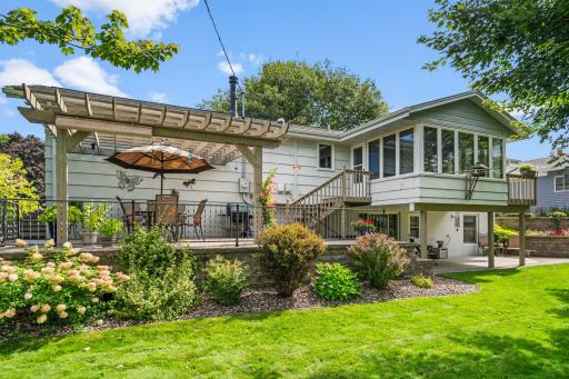 Private back yard with deck, two (2) large patios - one with Trellis for shade and meticulously landscaped - this is sure to impress!