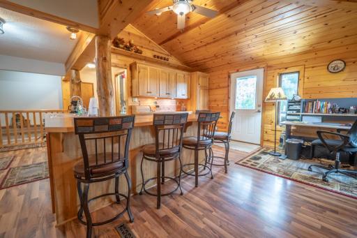 From this angle you can see the breakfast bar better along with the dining area currently being used as an office and the white door leads to the backyard which is fenced with a gazebo and two patios