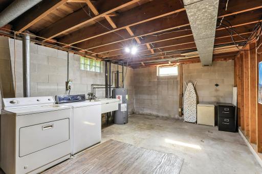 Spacious lower-level laundry with room that could be utilized for storage.