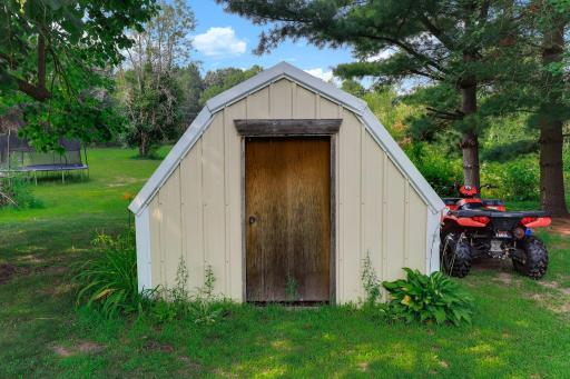Functional shed adds valuable storage and organization to the property.
