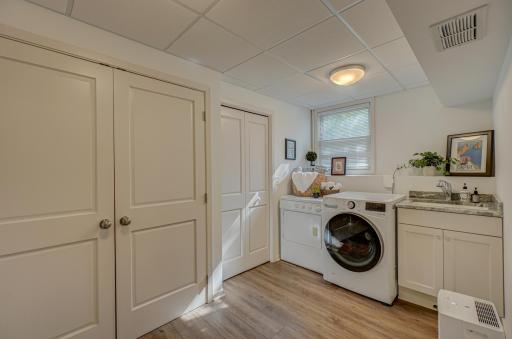 Laundry day made easy in this dedicated spacious lower level laundry room
